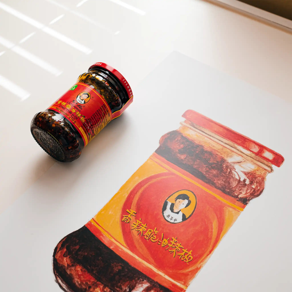 Jar of chili paste with a printed label on a white surface
