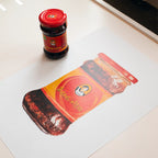 Red bottle with matching packaging on a white surface