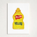 A square art print featuring a stylized yellow mustard bottle with the French's logo and the word 'YELLOW' in blue, displayed against a textured off-white wall.