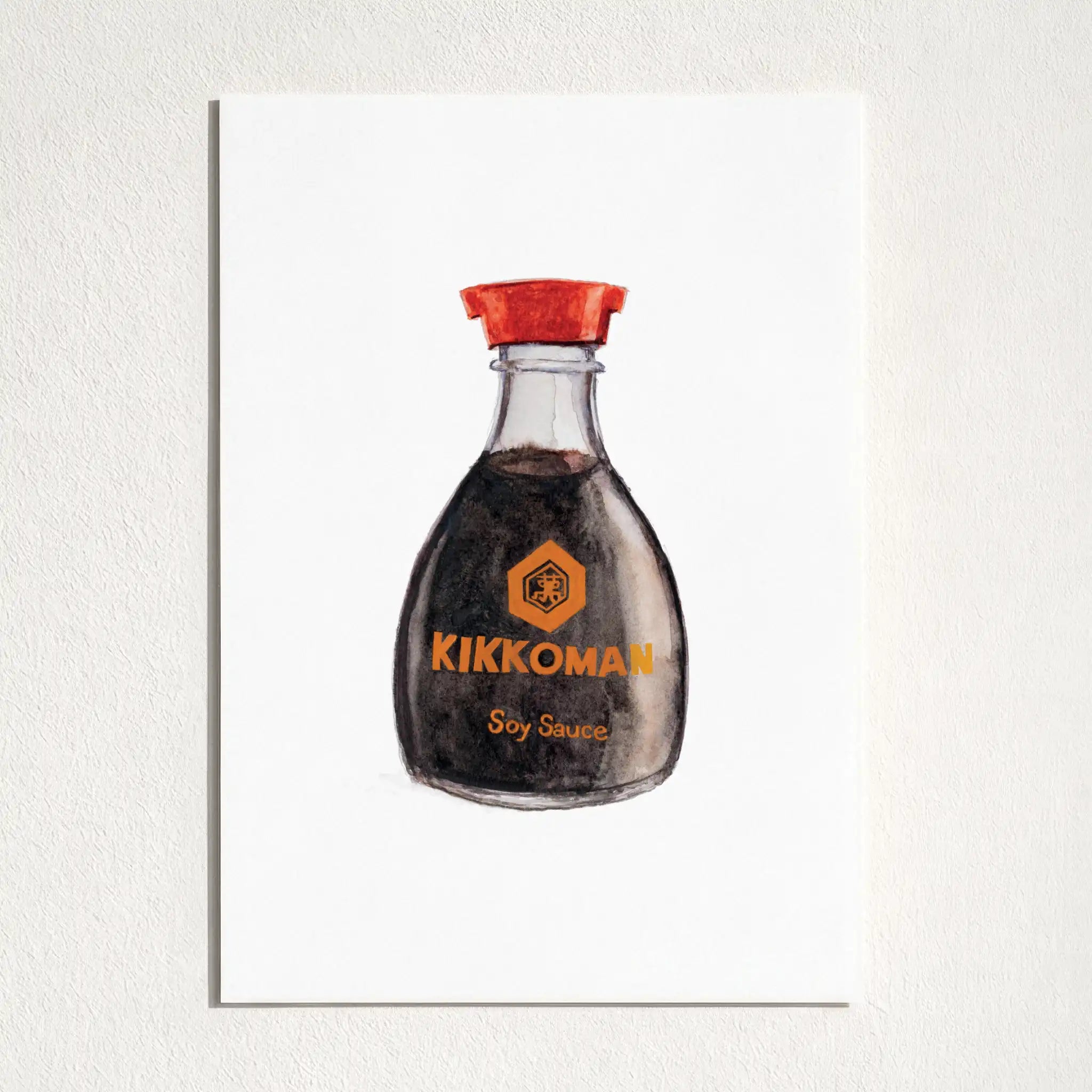 A vertical art print featuring a watercolor illustration of a Kikkoman soy sauce bottle, mounted on a textured white wall.