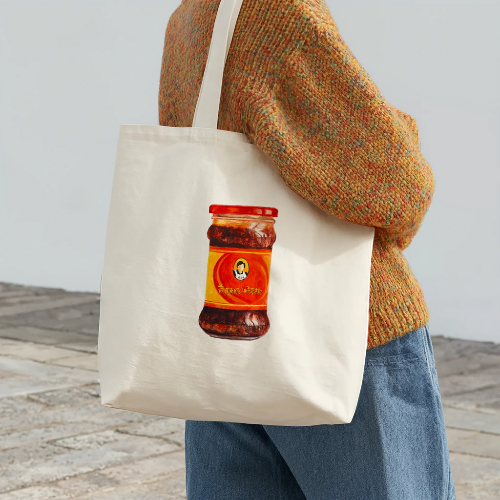 spicy chili crisp cotton tote bag with original watercolor design, shown as an everyday carry bag