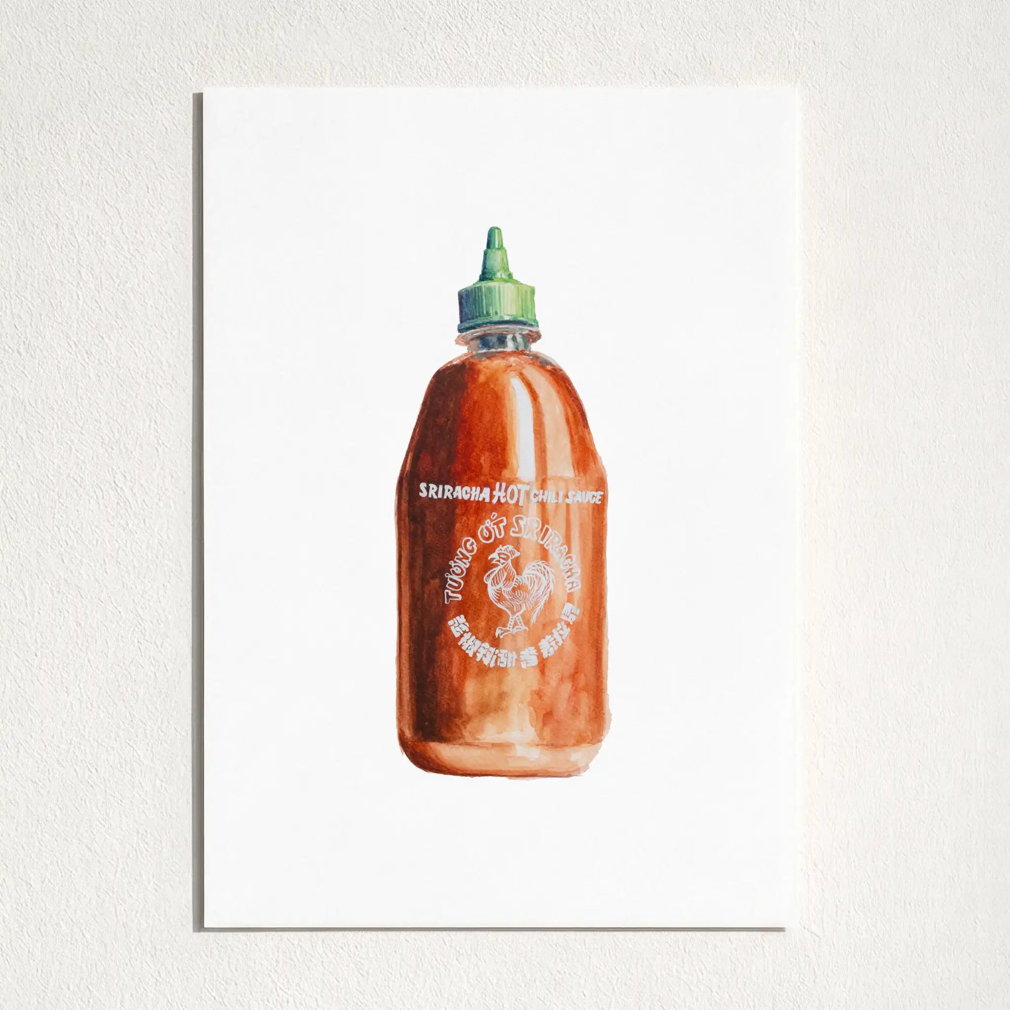 A minimalist art print depicting a watercolor illustration of a Sriracha hot sauce bottle, mounted on a textured white wall.