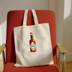 tabasco watercolor illustration cotton tote bag on a red chair in a modern interior
