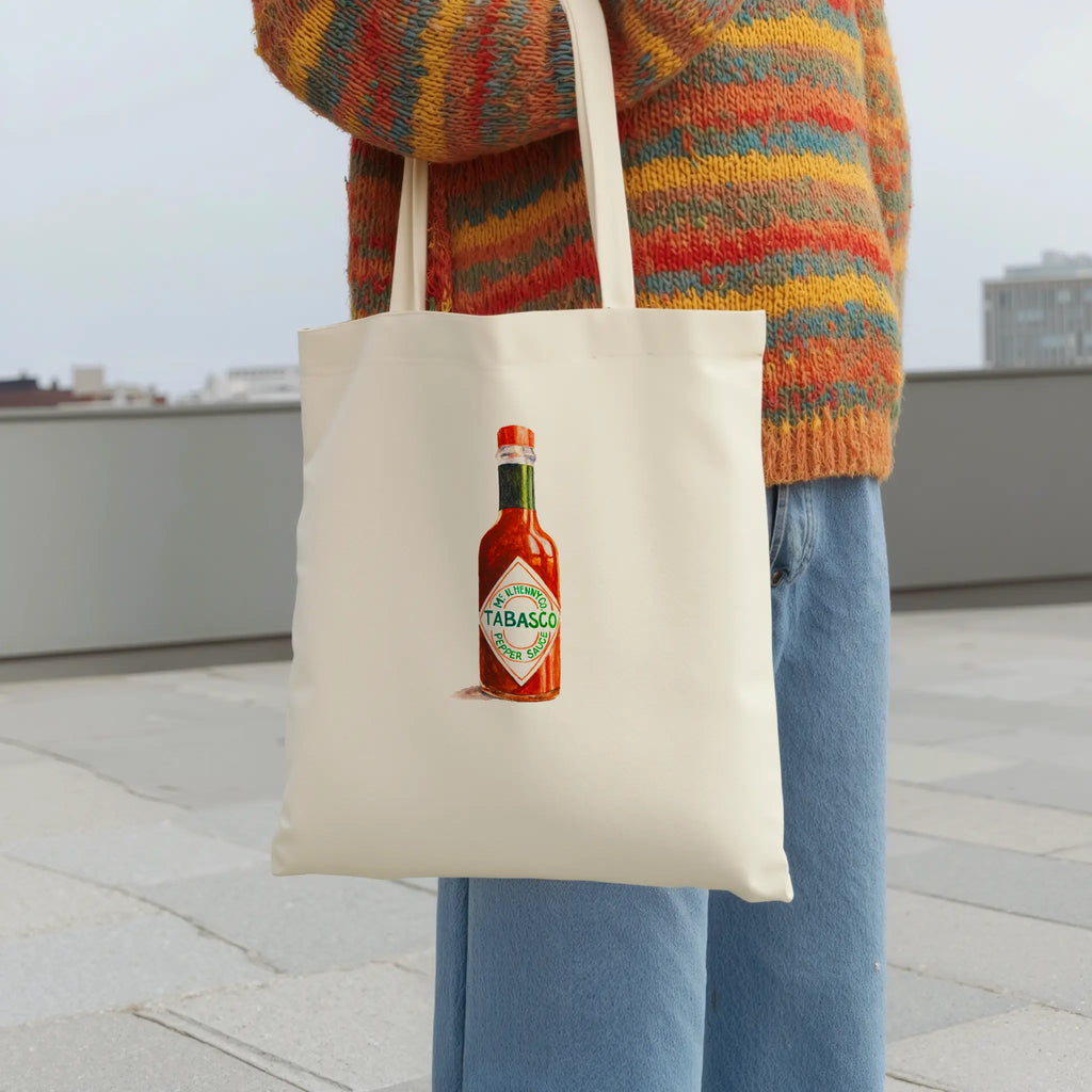 tabasco watercolor illustration cotton tote bag shown in an outdoor flat lay product view